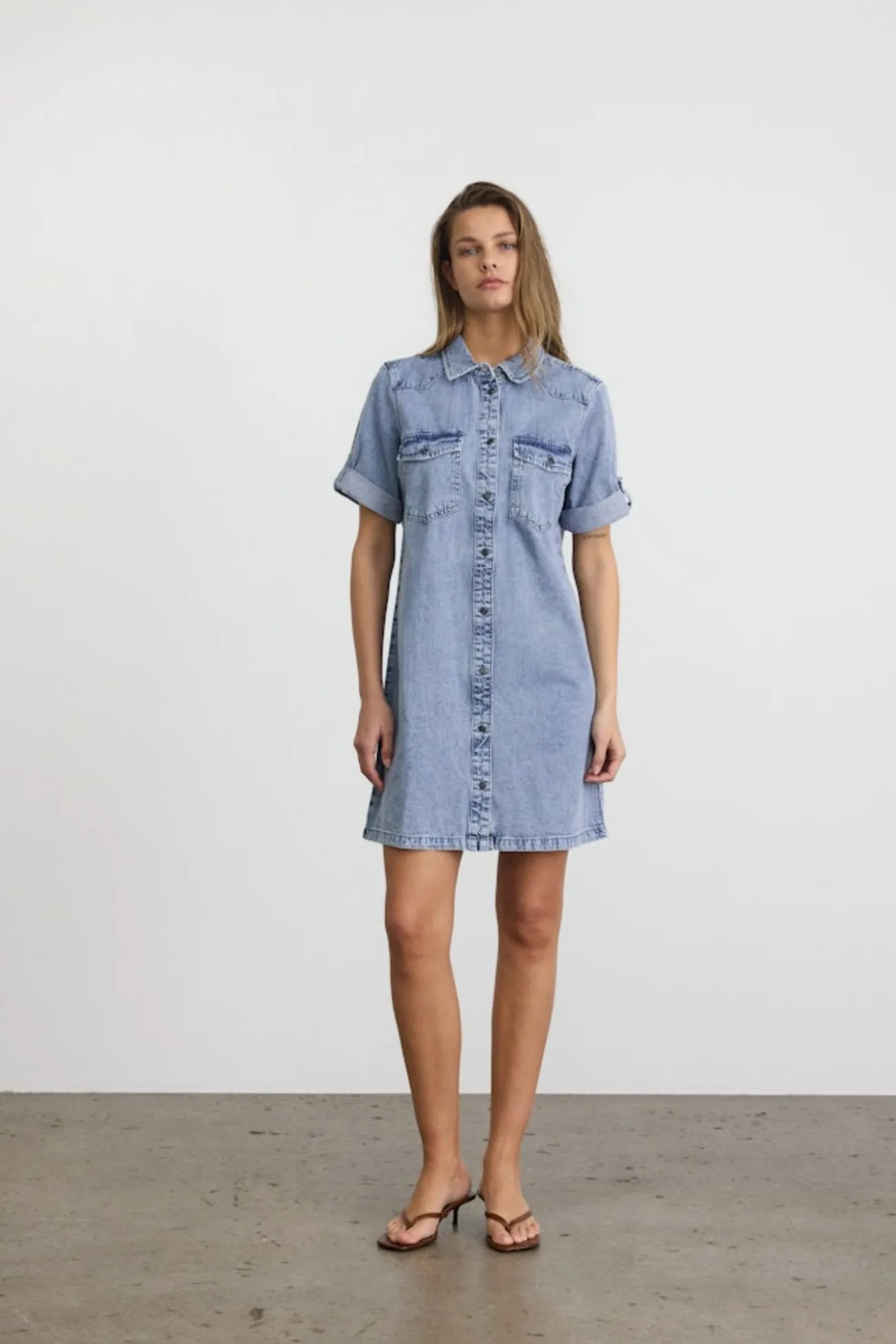 Vestido corto vaquero con manga corta, cuello y bolsillos frontales
